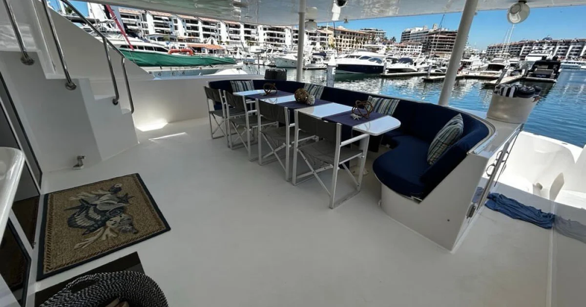 Shaded aft deck dining area of the 122 ft Hatteras superyacht at Marina Vallarta, Puerto Vallarta